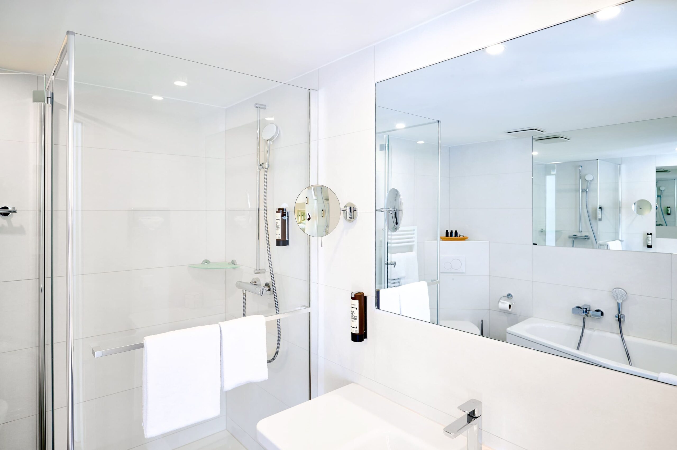Helles Badezimmer der Superior Suite im Kongresshotel Potsdam mit Dusche und Spiegel.